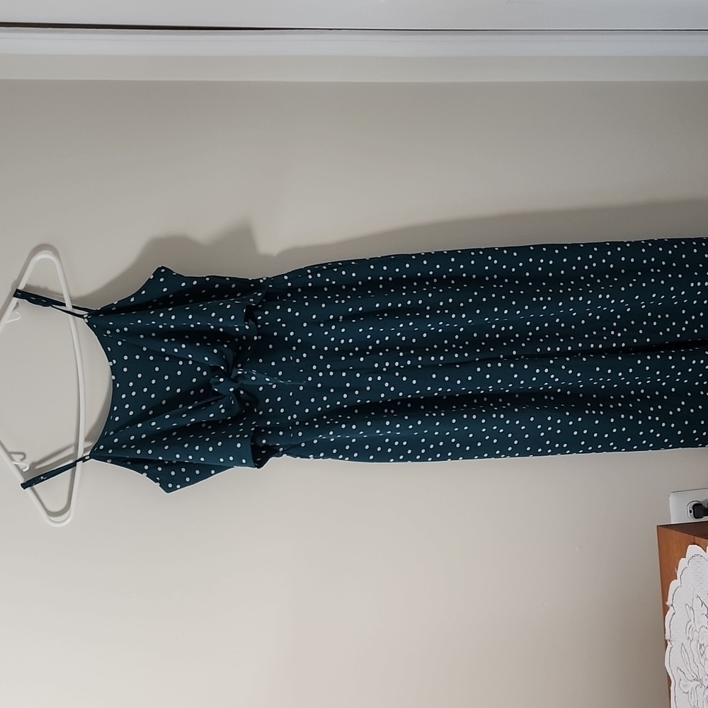 Dark green and white polka dot romper with wide legs.